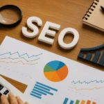 SEO-Tips-TDC-Blog-1-800x600-1-1 - Kihan Marketing SEO concept image with charts and a magnifying glass on a wooden desk, showing analytics graphs and a notebook edge.