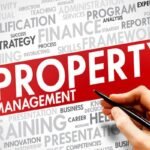 property-managent-SEO-1 - Kihan Marketing Hand holding a pen across a red PROPERTY MANAGEMENT banner, with a gray word cloud about finance, training, and strategy in the background.