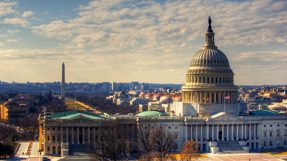 View of the U.S. Capitol dome with the Washington Monument in the distance on a clear day.