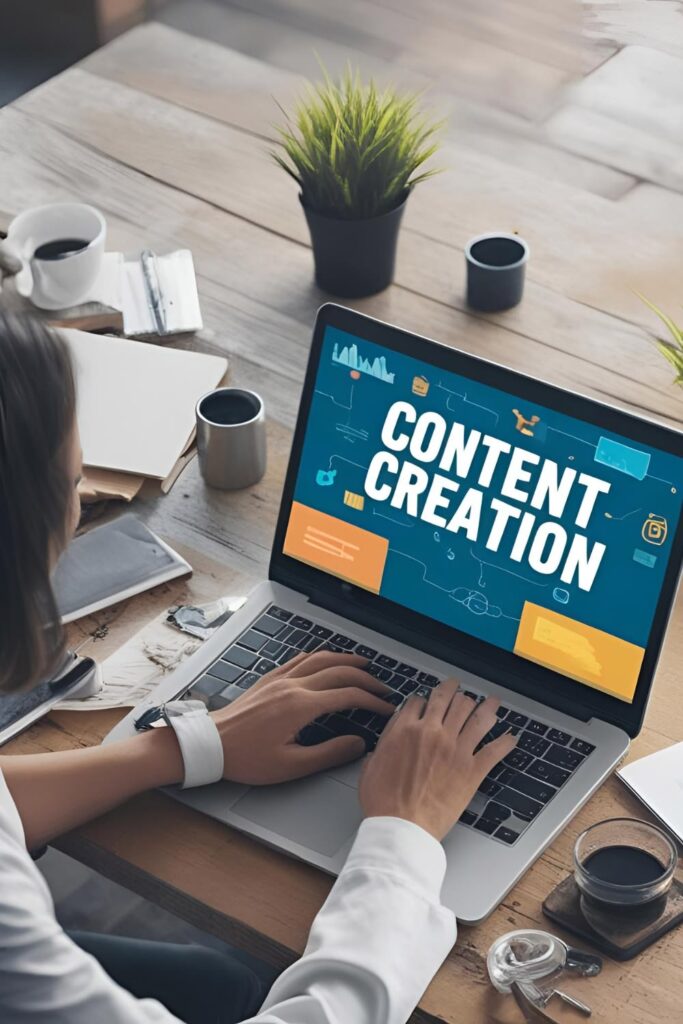 Person typing on a laptop displaying a bold 'Content Creation' graphic at a cluttered desk with coffee cups and plants nearby, emphasizing content creation work.