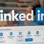 eb66162bb92e1e1c07f2ee1e80449025 - Kihan Marketing LinkedIn logo with a blurred workspace on the screen showing a Find companies search bar and 'See More' buttons beneath company icons.