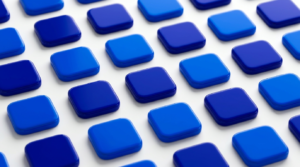 Abstract pattern of glossy blue rounded-square tiles in a grid, forming a geometric background.