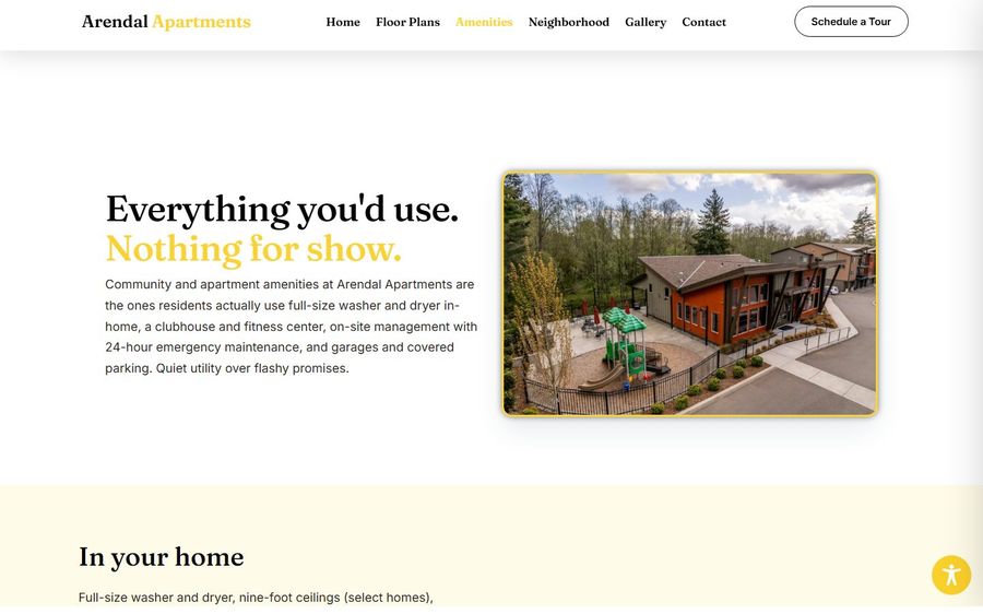 Community amenities hero: exterior of a wood-clad building with a fenced playground adjoining paved paths and trees.